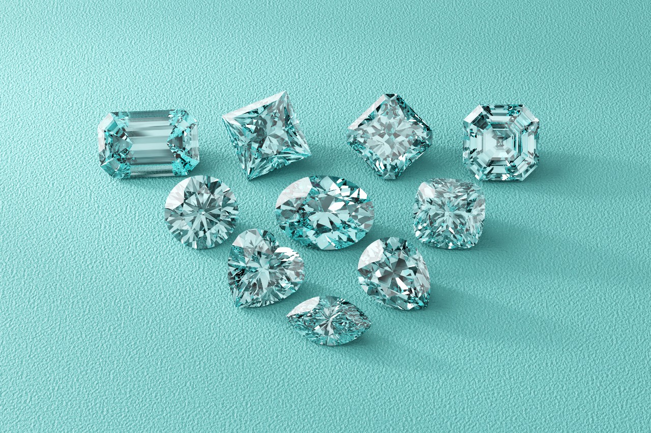 Ten sparkling diamonds of various cuts are arranged on a textured turquoise surface.